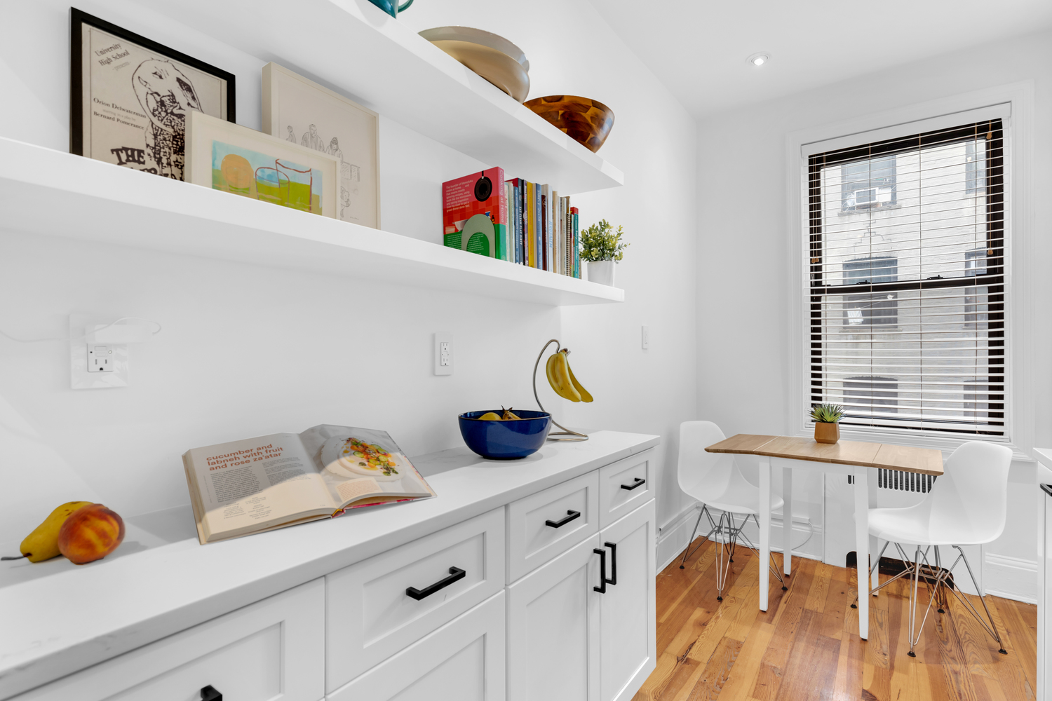 Luxury white shaker kitchen with matte black hardware, black-and-white star tile backsplash, quartz countertops, and hardwood floors – full renovation in Prospect Park Southwest, Brooklyn by SABI Construction